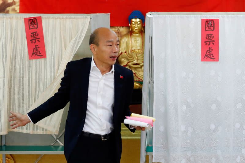 Taiwan's opposition Kuomintang Party (KMT) presidential candidate Han Kuo-yu arrives to cast his vote at a polling station during general elections in Kaohsiung