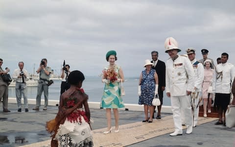 Queen Elizabeth II is greeted by a young girl on her arrival at Suva in Fiji, during the coronation world tour, December 1953 - Credit: Hulton Archive