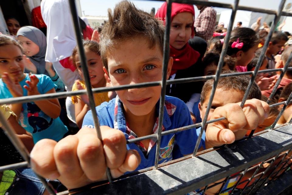 Syrian children play in the yard of their tent school in al-Rahma camp, a Syrain refugee camp in Beqaa Valley located east of Beirut.