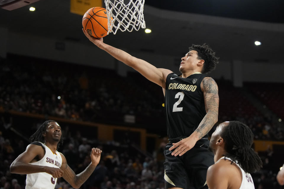 Colorado guard KJ Simpson (2) drives between Arizona State guard Brycen Long, left, and guard Frankie Collins during the first half of an NCAA college basketball game Saturday, Jan. 6, 2024, in Tempe, Ariz. (AP Photo/Rick Scuteri)