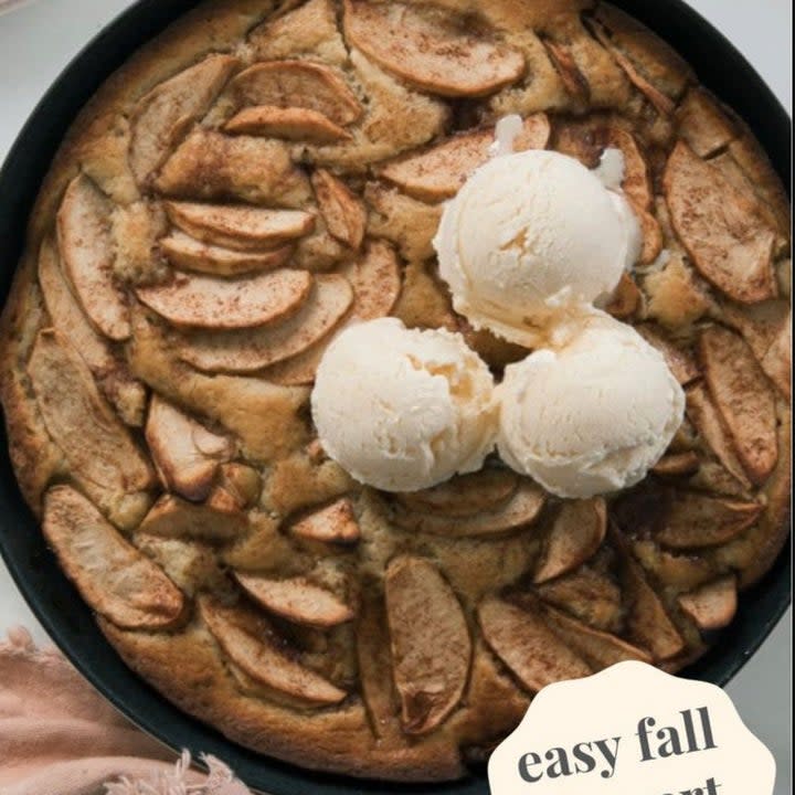 chai spiced apple cake in a skillet with ice cream