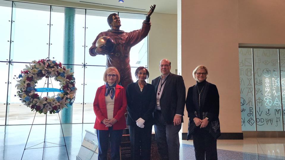 Carol Lovelady, left, councilmember Freda Powell, airport director Mike Conner and Susan Esler stand by the wreath and statue that honor the life and achievements of Rick Husband during a ceremony held Wednesday morning at the Rick Husband Amarillo International Airport, on the 20th anniversary of the 2003 shuttle tragedy.