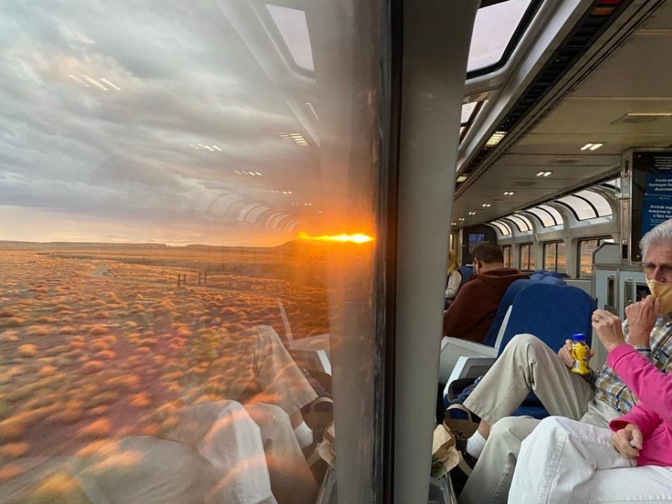 sun setting in utah outside an amtrak train window