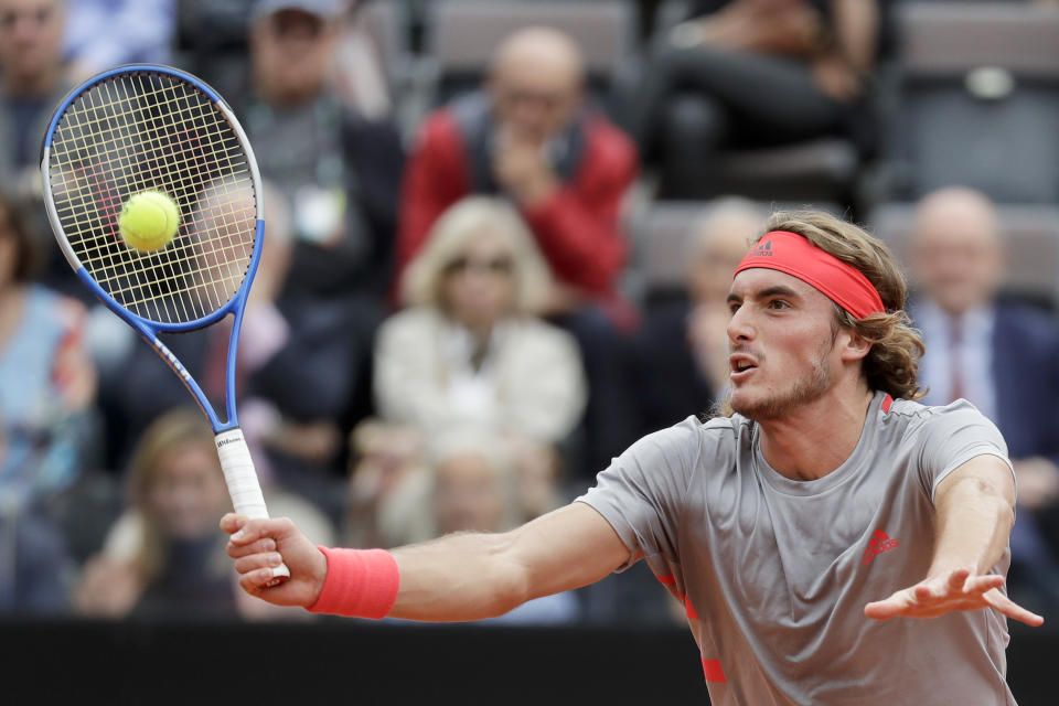 Stefanos Tsitsipas of Greece returns the ball to Rafael Nadal of Spain during a semifinal match at the Italian Open tennis tournament, in Rome, Saturday, May 18, 2019. (AP Photo/Andrew Medichini)