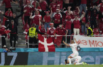 Denmark's Yussuf Poulsen, bottom, celebrates after scoring his side's second goal during the Euro 2020 soccer championship group B match between Denmark and Russia at the Parken stadium in Copenhagen, Monday, June 21, 2021. (AP Photo/Martin Meissner, Pool)