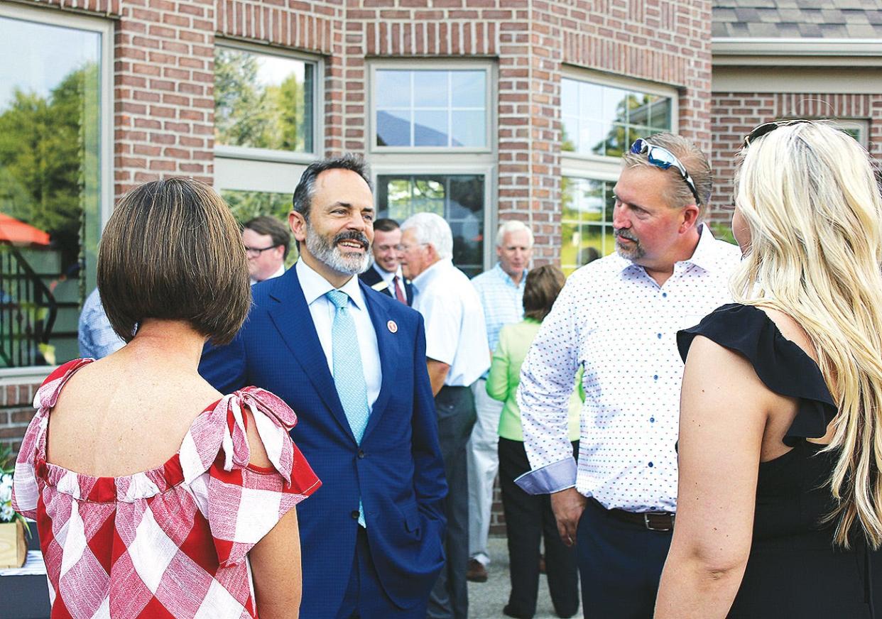 Former Gov. Matt Bevin (left) speaks with Eric Baker (right) and others guests at his campaign fundraiser on July 26, 2018 at the Corbin home of Baker.