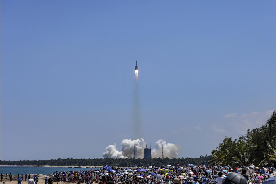 In this photo released by Xinhua News Agency, people gather at the beach side as they watch the Long March 5B Y3 carrier rocket, carrying Wentian lab module, lift off from the Wenchang Space Launch Center in Wenchang in southern China's Hainan Province Sunday, July 24, 2022. On a hot Sunday afternoon, with a large crowd of amateur photographers and space enthusiasts watching, China launched the Wentian lab module from tropical Hainan Island. (Zhang Liyun/Xinhua via AP)