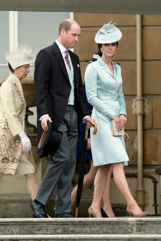 <p>For the first garden party of the season, the Duke and Duchess coordinate their pastel looks. Prince William wore a silk blue vest to match the Duchess's satin blue Chistopher Kane suit dress. She topped off the outfit with a fascinator from John Locke & Co. </p>