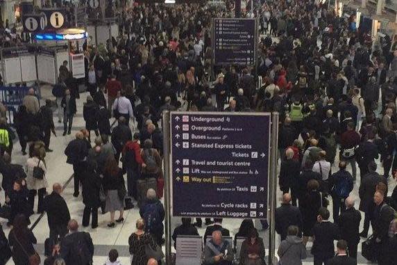 Passengers wait for information at Liverpool Street station (@truthseeker7890)