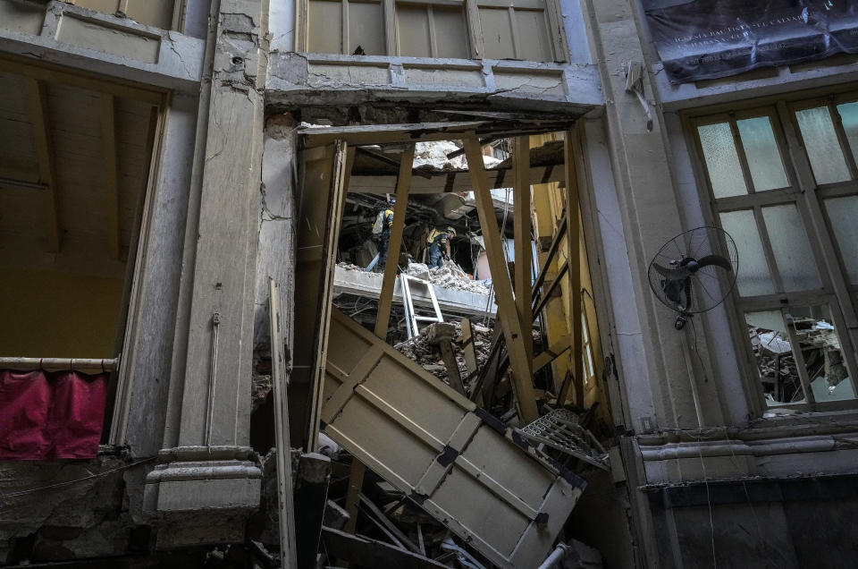 A recovery team searches through the rooms of the Hotel Saratoga as seen from inside the Calvary Baptist Church, also damaged by an explosion that devastated the hotel, in Old Havana, Cuba, Wednesday, May 11, 2022. The May 6th explosion killed dozens and badly damaged Cuba's most important Baptist church, which sits next door. (AP Photo/Ramon Espinosa)