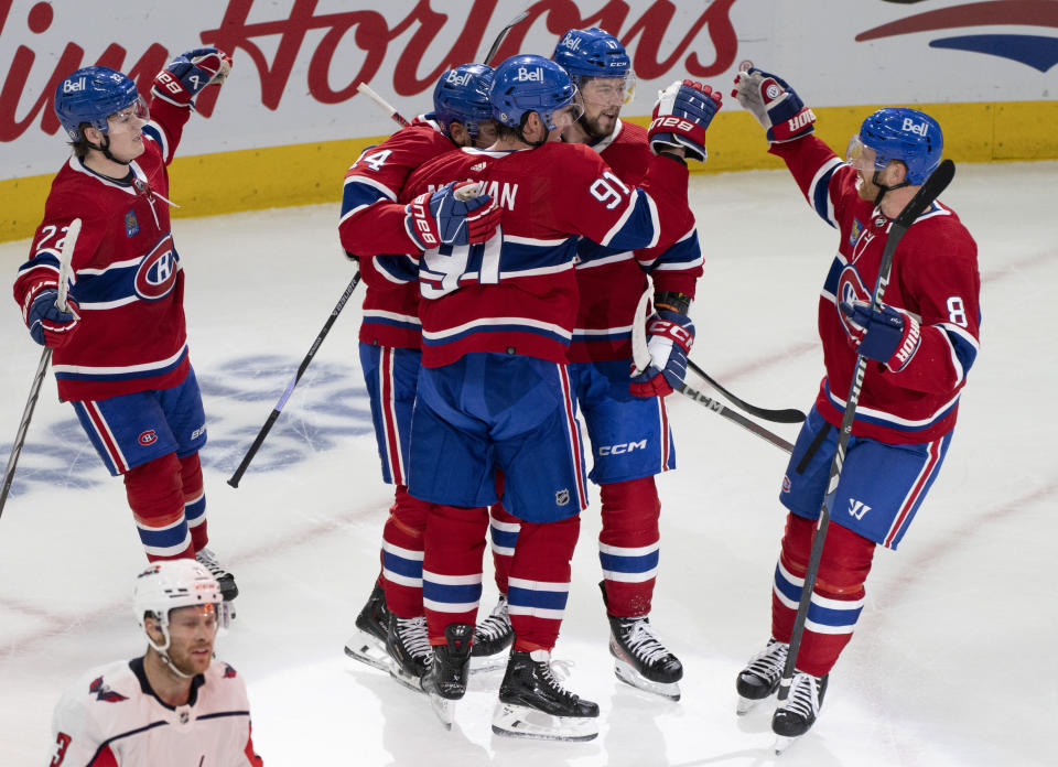 Montreal Canadiens' Sean Monahan (91) celebrates his goal with teammates during the first period of an NHL hockey game against the Washington Capitals, in Montreal on Saturday, Oct. 21, 2023. (Christinne Muschi/The Canadian Press via AP)