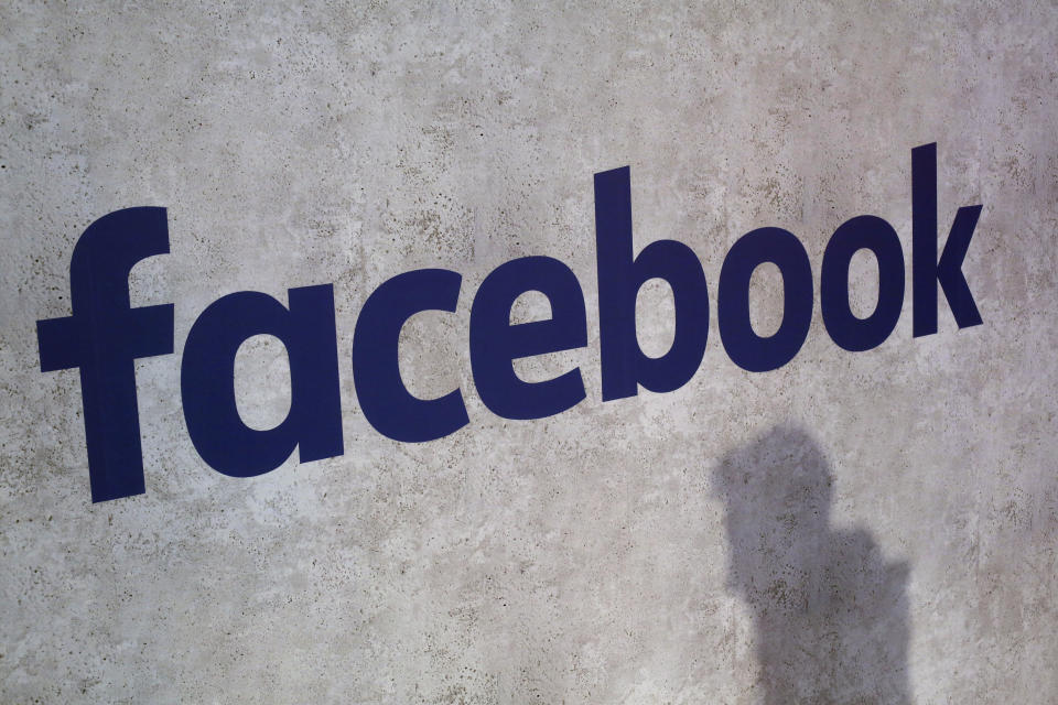 FILE - This Jan. 17, 2017, file photo shows a Facebook logo displayed in a start-up companies gathering at Paris' Station F in Paris. The French government is unveiling plans to slap a 3 percent tax on the French revenues of internet giants like Google, Amazon and Facebook. (AP Photo/Thibault Camus, File)