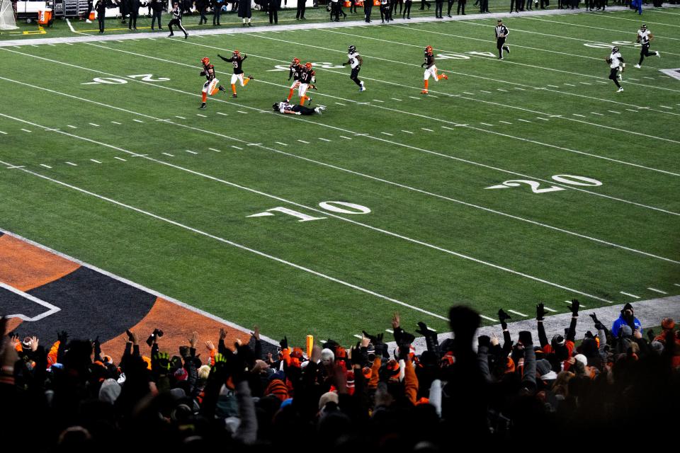 Bengals defensive end Sam Hubbard returns a fumble 98-yards for a touchdown in the fourth quarter during an AFC wild card playoff game on Sunday, Jan. 15, 2023, in Cincinnati.
