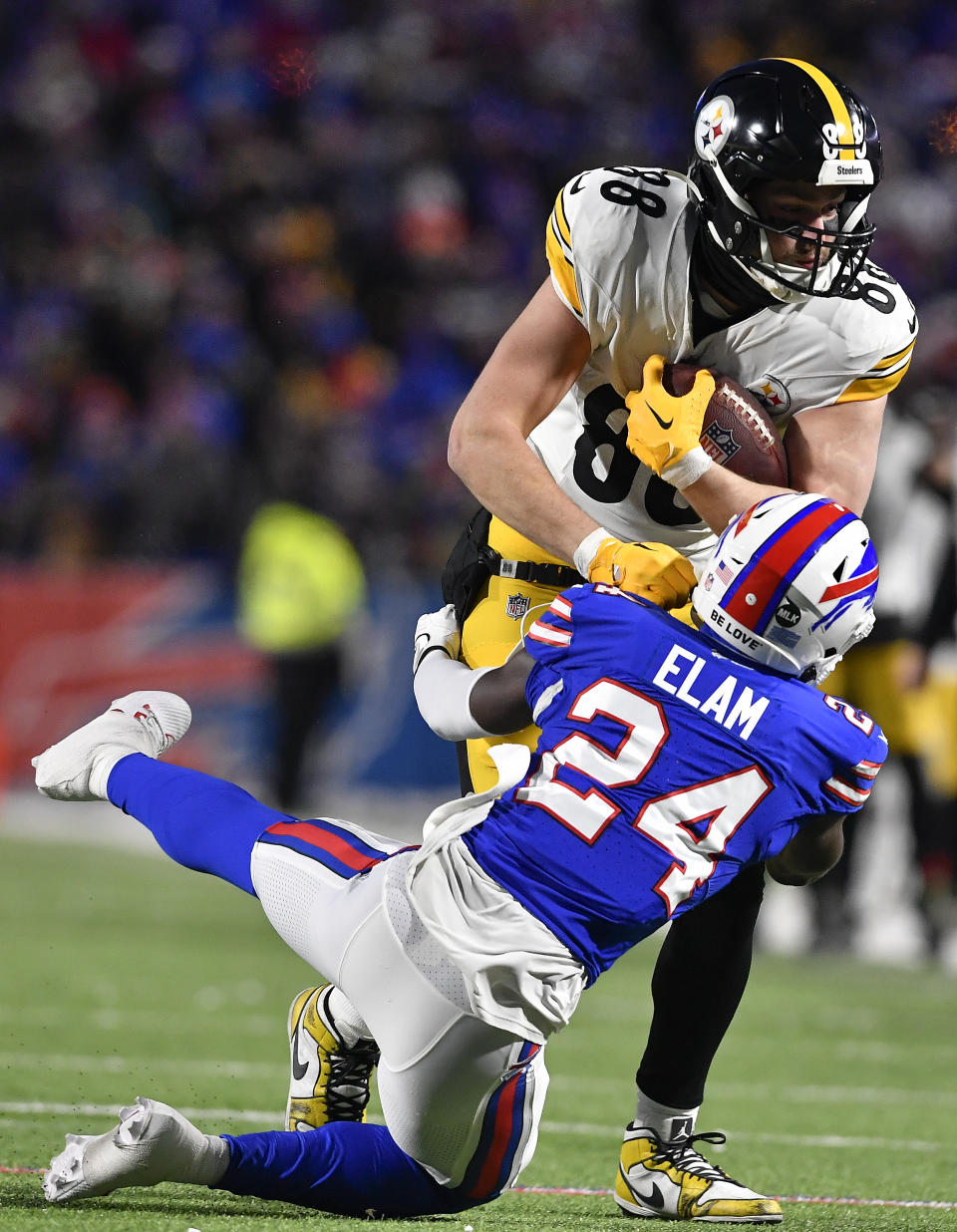 Buffalo Bills cornerback Kaiir Elam (24) tackles Pittsburgh Steelers tight end Pat Freiermuth (88) during the second quarter of an NFL wild-card playoff football game, Monday, Jan. 15, 2024, in Buffalo, N.Y. (AP Photo/Adrian Kraus)