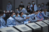 In this photo released by Xinhua News Agency, technical personnel work at the Beijing Aerospace Control Center (BACC) in Beijing, Thursday Dec. 3, 2020. A Chinese lunar probe lifted off from the moon Thursday night with a cargo of lunar samples on the first stage of its return to Earth, state media reported. (Jin Liwang/Xinhua via AP)