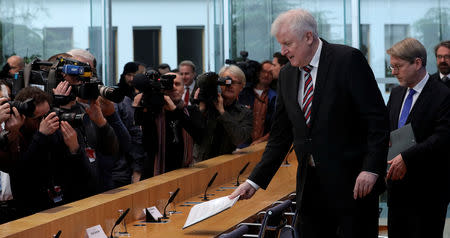 Hans-Eckhard Sommer head of the Federal Office for Migration and Refugees (BAMF) and German Interior Minister Horst Seehofer arrive to present the 2018 asylum report in Berlin, Germany, January 23, 2019. REUTERS/Fabrizio Bensch