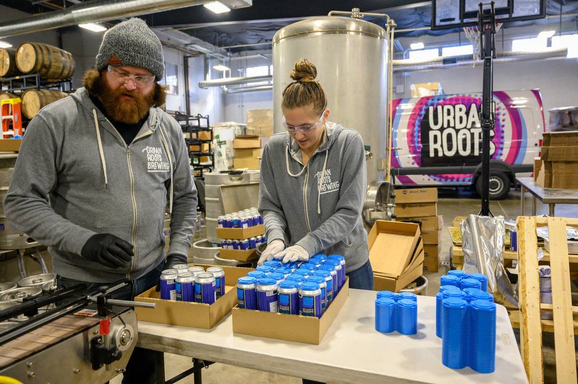 Peter Salmond, brewer, and Alli Okumura pack canned beer at Urban Roots Brewery & Smokehouse on Thursday Jan. 29, 2019 in Sacramento.