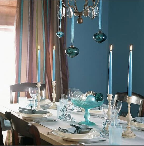 Hang your ornaments from the chandelier above your dining table with silk ribbon.