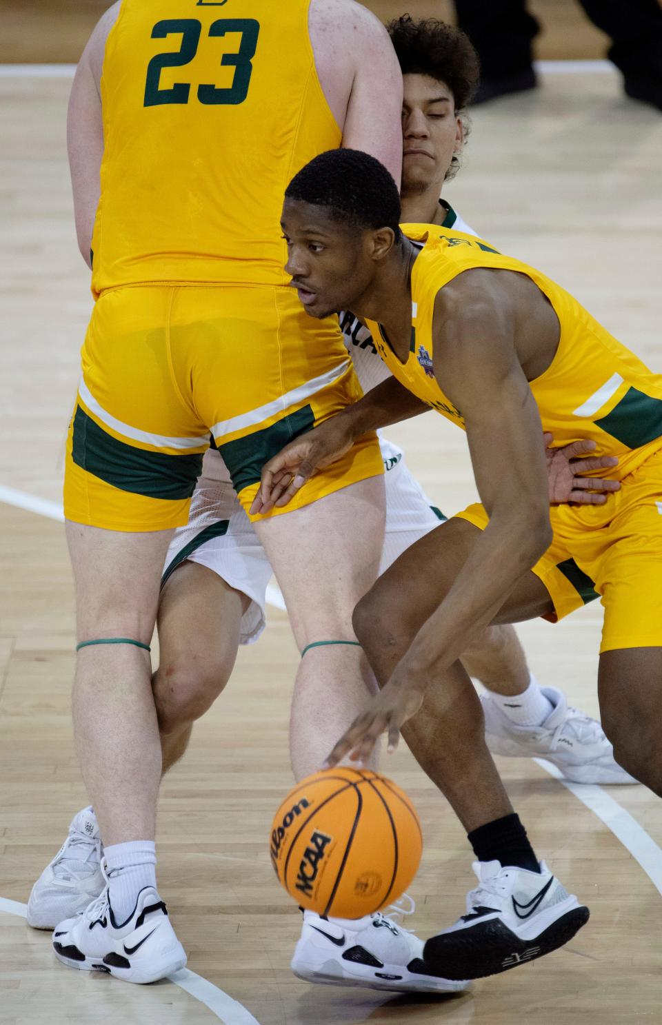 Black Hills State's Sindou Cisse (4) uses the pick of PJ Hayes (23) to elude Northwest Missouri's Diego Bernard (1) during their semifinal game of the 2022 NCAA DII Men's Basketball Championship Elite Eight at Ford Center in Evansville, Ind., Thursday, March 24, 2022.
