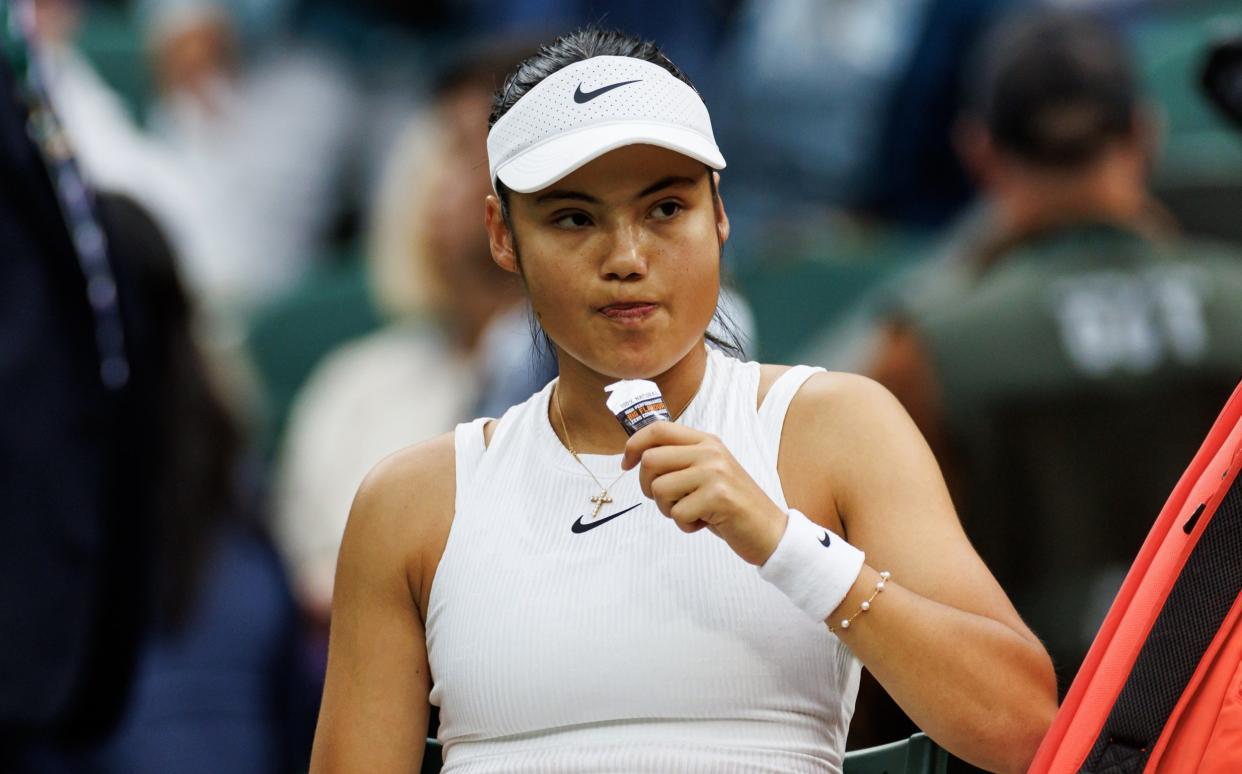 Emma Raducanu of Great Britain eats during a change of end during her match against Lulu Sun of New Zealand in the fourth round of the ladies singles during day seven of The Championships Wimbledon 2024 at All England Lawn Tennis and Croquet Club on July 07, 2024 in London, England