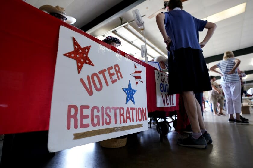 A voter registration table is seen at a political event for Texas gubernatorial candidate Beto O'Rourke, Wednesday, Aug. 17, 2022, in Fredericksburg, Texas. On the brink of November's midterm elections, both full-time election workers in rural Gillespie County suddenly and stunningly quit this month with less than 70 days before voters start casting ballots. (AP Photo/Eric Gay)