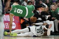 Milwaukee Bucks' Wesley Matthews fouls Boston Celtics' Derrick White during the second half of Game 3 of an NBA basketball Eastern Conference semifinals playoff series Saturday, May 7, 2022, in Milwaukee. The Bucks won 103-101 to take a 2-0 lead in the series. (AP Photo/Morry Gash)