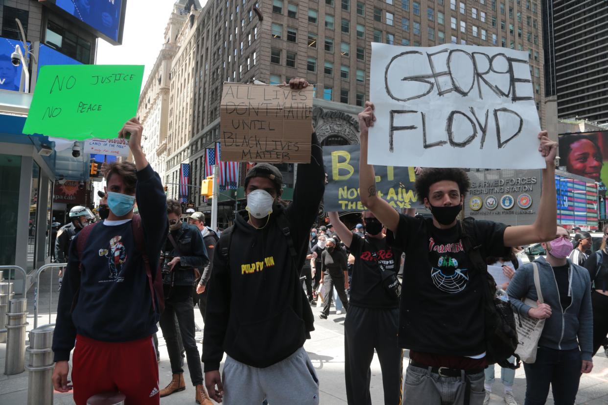 In this file photo, protesters gather in New York Times Square near the NYPD booth to protest the killing of George Floyd.