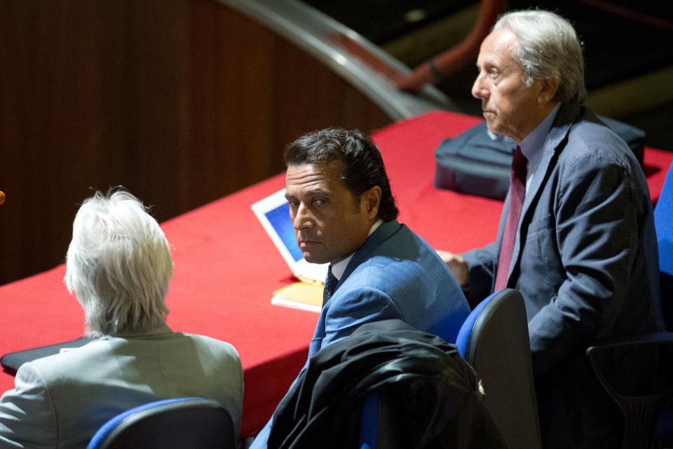 Captain Francesco Schettino, center, sits in the court room of the converted Teatro Moderno theater on the second day of his trial, in Grosseto, Italy, Tuesday, Sept. 24, 2013. The captain of the wrecked Costa Concordia is charged with manslaughter, causing the shipwreck and abandoning ship before the luxury cruise liner's 4,200 passengers and crew could be evacuated on Jan. 13, 2012 when the ship collided with a reef off the Tuscan island of Giglio, killing 32 people. Schettino blames his helmsman for botching a last-minute corrective maneuver that he contends could have prevented the massive cruise ship's collision with the reef. (AP Photo/Andrew Medichini)