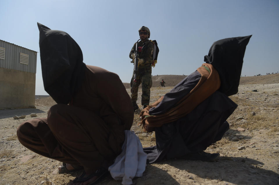 An Afghan National Army commando arrests men pretending to be Taliban fighters during a military exercise at the Kabul Military Training Center on the outskirts of Kabul on Oct. 17, 2017.