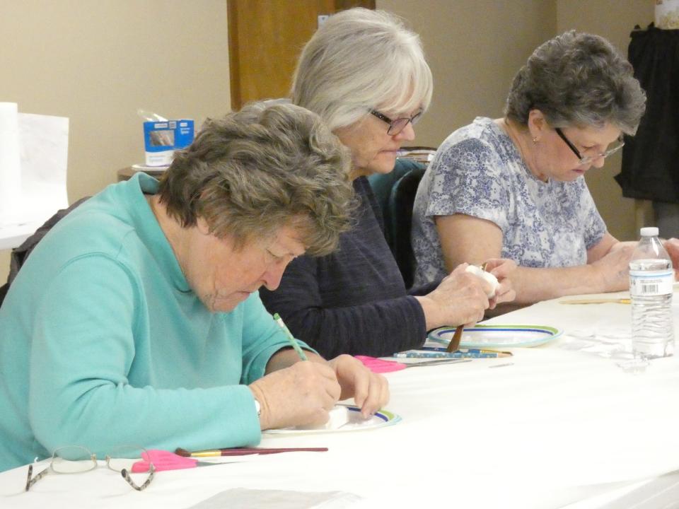 Bonnie Bays, Roxann Gerstenslager and Sarah Bayless, from left, carve bars of soap during a craft program on Wednesday at the Crawford County Council on Aging.