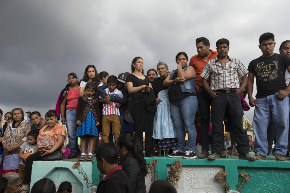 FILE - In this March 12, 2017 file photo, people attend the burial of 14-year-old Ana Roselia Perez Junay, who died in a fire at the Virgen de la Asunción Safe Home, at the cemetery in Zaragoza, Guatemala. The fire on March 8th that killed 40 girls at the shelter started when girls took a match to a foam mattress to protest the abuse they had suffered there. (AP Photo/Moises Castillo, File)