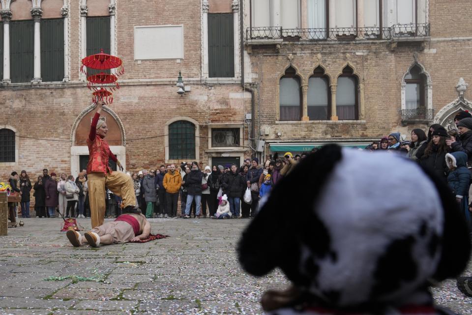 Street artist called 'Arteare' perform traditional expressions of oriental art between fakirism, dance and fire, during the opening street show of the Venice Carnival, in Venice, Italy, Saturday, Jan. 27, 2024. Venice is marking the 700th anniversary of the death of Marco Polo with a yearlong series of commemorations, starting with the opening of Carnival season honoring one of the lagoon city's most illustrious native sons. (AP Photo/Luca Bruno)