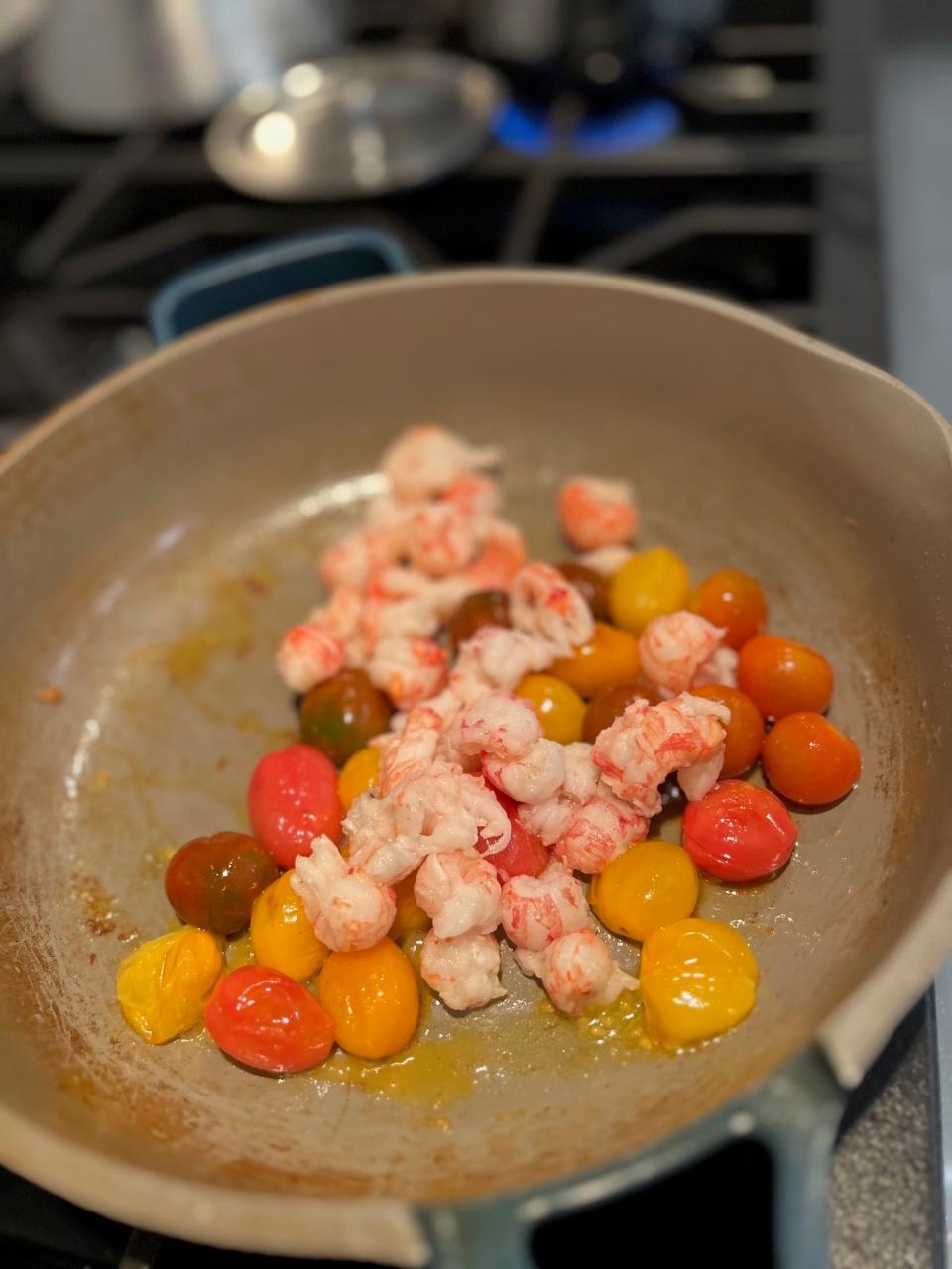 Tomatoes and langostino in a pan