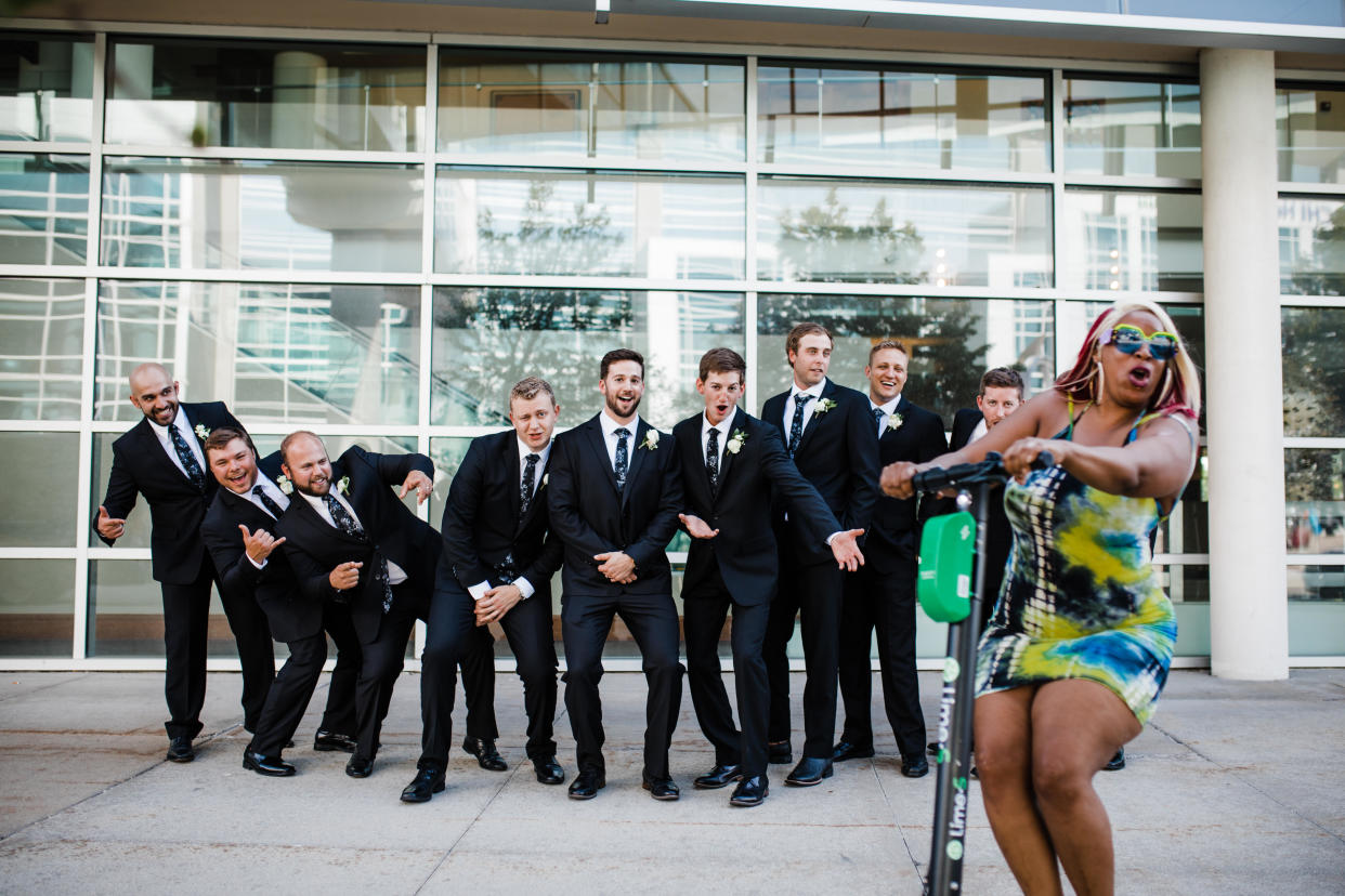 Kenyatta Jefferson rode in front of a groomsmen group photo on a Lime scooter in Omaha, Nebraska. (Credit: Photographers Molly and Joshua Giangreco from Molly B. Photography)