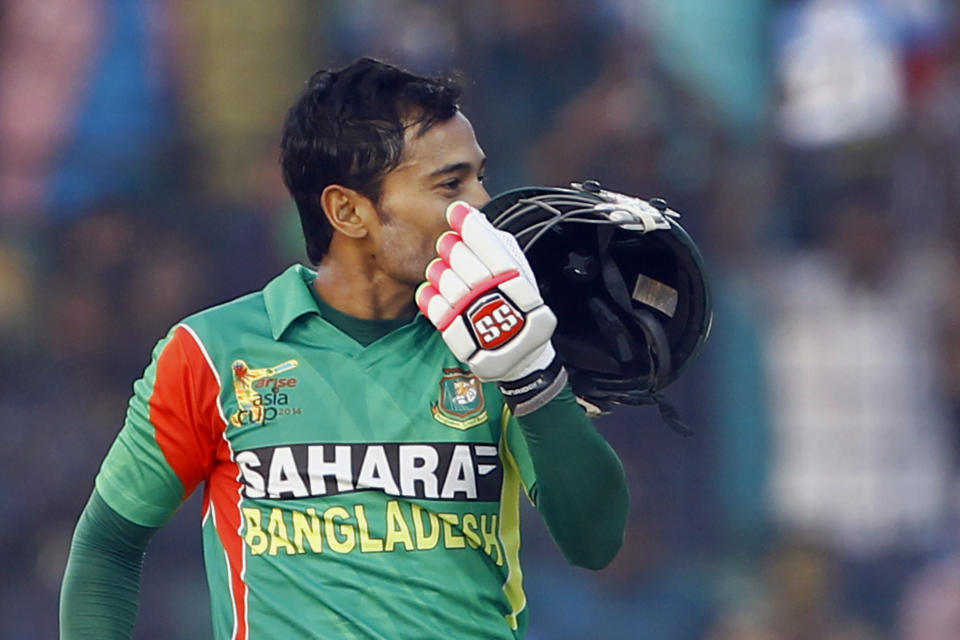 Bangladesh's Mushfiqur Rahim kisses his helmet after scoring a century during the Asia Cup one-day international cricket tournament against India in Fatullah, near Dhaka, Bangladesh, Wednesday, Feb. 26, 2014. (AP Photo/A.M. Ahad)