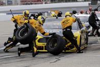 The pit crew scrambles as driver Brad Keselowski makes a pitstop during a NASCAR Cup Series auto race, Sunday, Aug. 2, 2020, at the New Hampshire Motor Speedway in Loudon, N.H. (AP Photo/Charles Krupa)