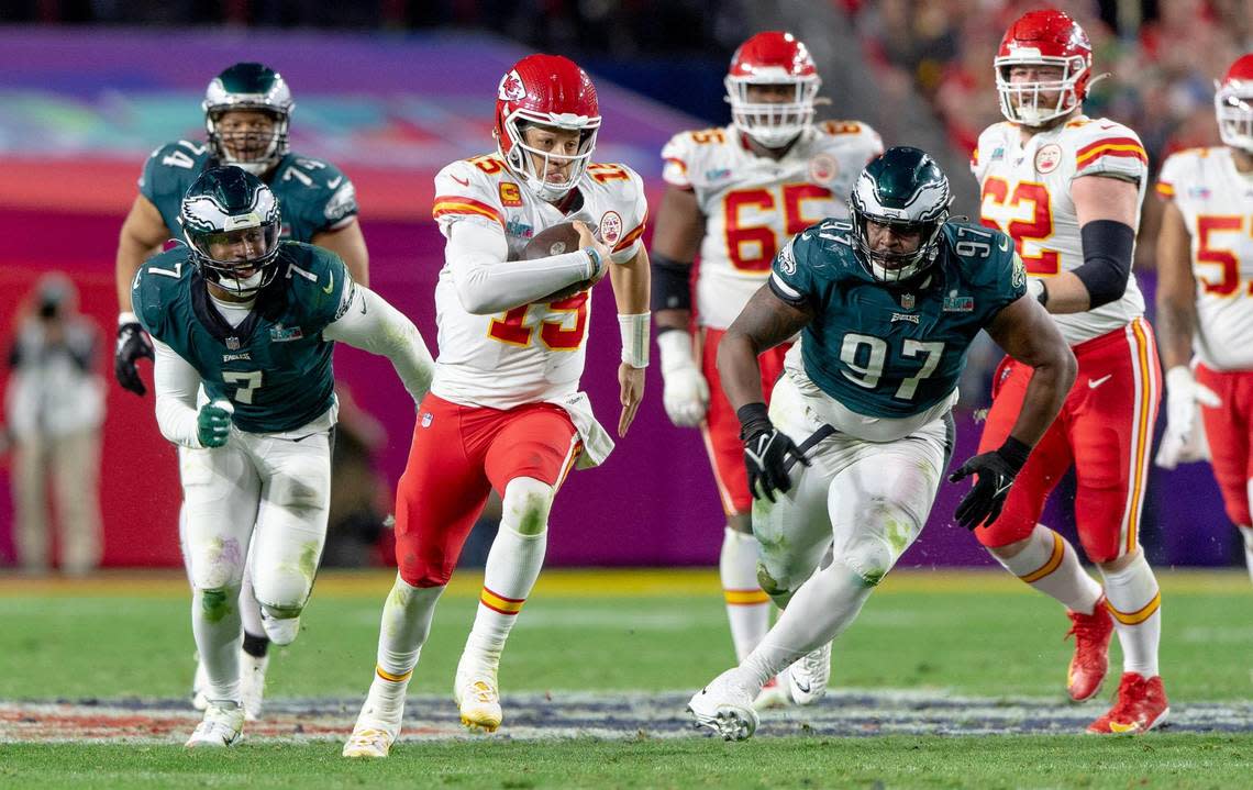 Kansas City Chiefs quarterback Patrick Mahomes (15) outruns Philadelphia Eagles defensive tackle Javon Hargrave (97) during the Super Bowl LVII football game on Sunday, Feb. 12, 2023, in Glendale, Ariz.