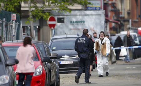 Belgium police officers search the area during a police operation in Etterbeek, near Brussels, Belgium, April 9, 2016. REUTERS/Yves Herman