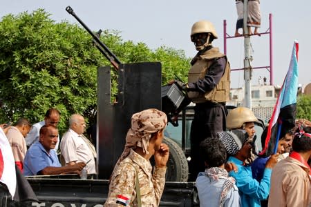 FILE PHOTO: Members of UAE-backed southern Yemeni separatists forces are seen together with their supporters as they march during a rally in southern port city in Aden