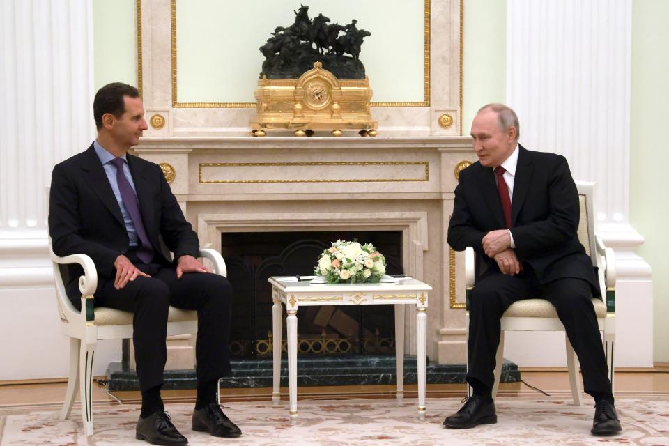 Russian President Vladimir Putin, right, and Syrian President Bashar Assad talk during their meeting at the Kremlin in Moscow, Russia, Wednesday, March 15, 2023. (Vladimir Gerdo, Sputnik, Kremlin Pool Photo via AP)