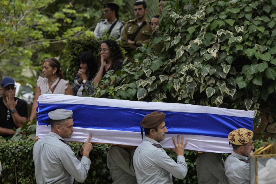 Israeli soldiers carry the flag-covered coffin of Col. Roi Levy during his funeral at the Mount Herzl cemetery in Jerusalem on Monday, Oct. 9, 2023. Col. Roi Levy was killed after Hamas militants stormed from the blockaded Gaza Strip into nearby Israeli towns. Israel's vaunted military and intelligence apparatus was caught completely off guard, bringing heavy battles to its streets for the first time in decades. (AP Photo/Maya Alleruzzo)