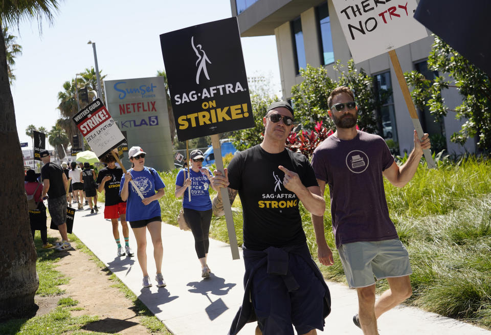 Picketers strike outside Netflix studios on Thursday, July 20, 2023, in Los Angeles. The actors strike comes more than two months after screenwriters began striking in their bid to get better pay and working conditions. (AP Photo/Chris Pizzello)