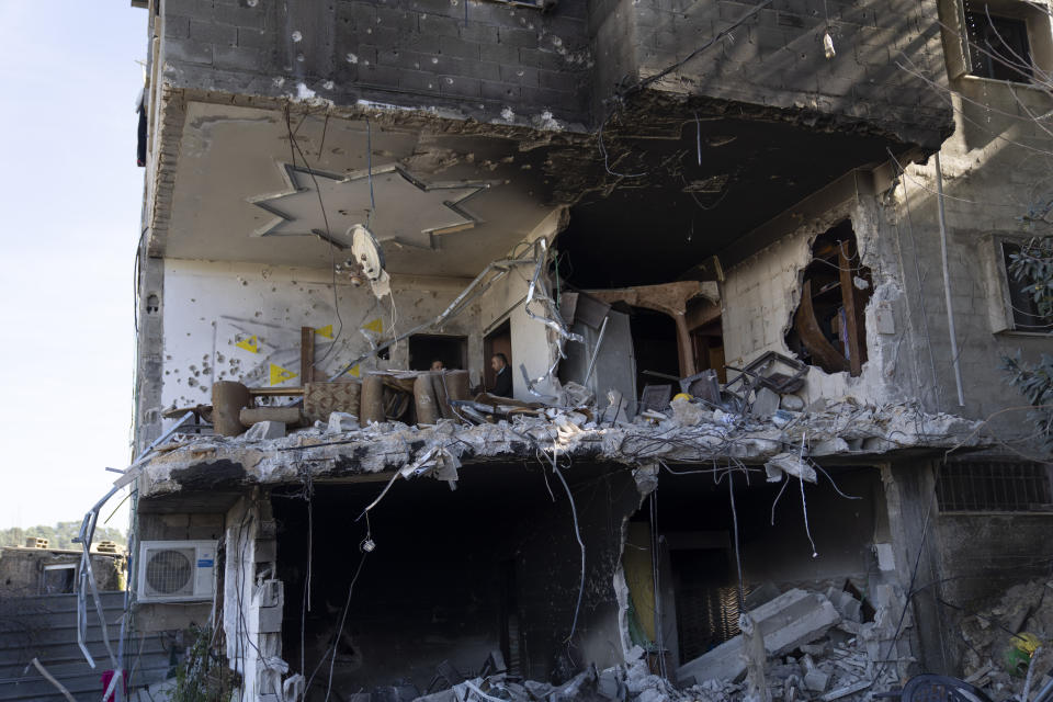 Palestinians inspect a destroyed house following an Israeli army operation in the West Bank refugee camp of Nour Shams, Tulkarem, Thursday, Feb. 8, 2024. The Al Aqsa Martyrs' Brigades, a Palestinian militant group, said three of its members were killed in the Israeli raid. Israel said its troops shot the militants after an exchange of fire. (AP Photo/Nasser Nasser)