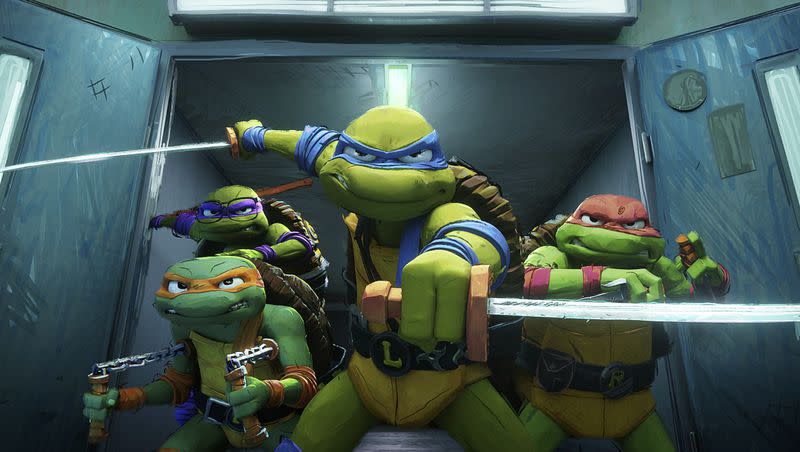 This image released by Paramount Pictures shows, from left, Michelangelo, “Mikey,” voiced by Shamon Brown Jr., Donatello, “Donnie,” voiced by Micah Abbey, background left, Leonardo, “Leo,” voiced by Nicolas Cantu, and Raphael, “Raph,” voiced by Brady Noon, in the film “Teenage Mutant Ninja Turtles: Mutant Mayhem.”