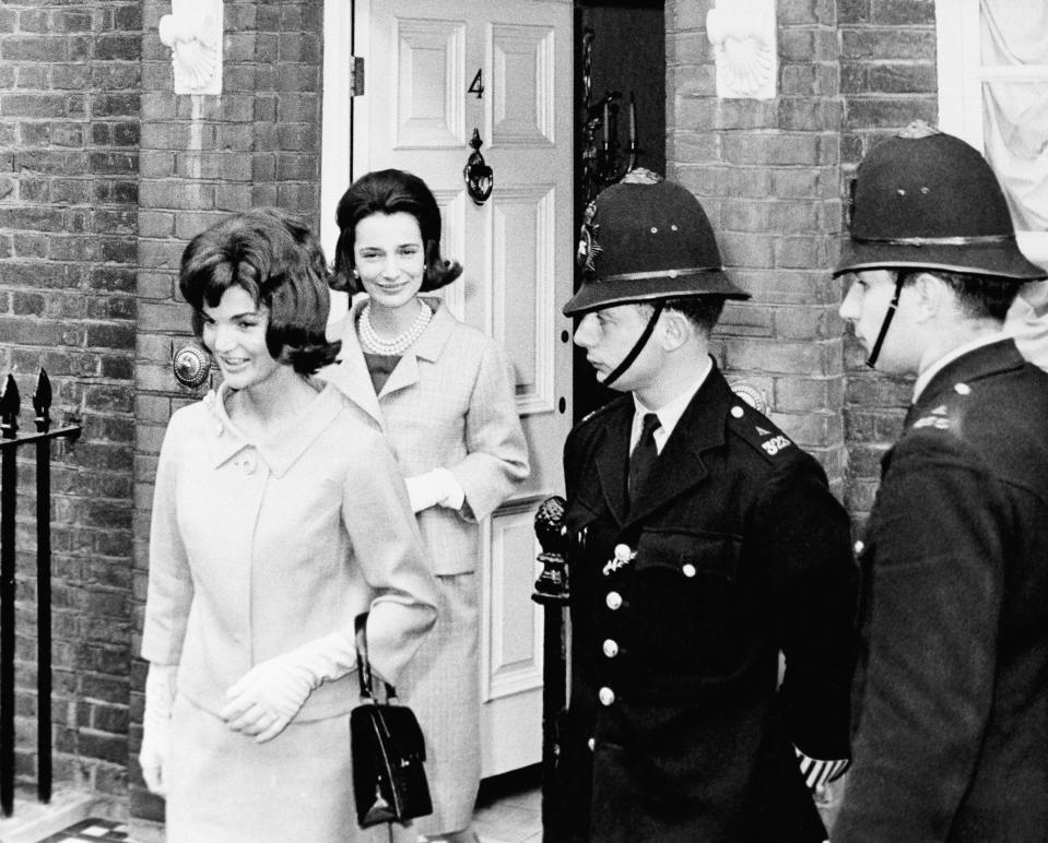 FILE - In this June 6, 1961 file photo, Jacqueline Kennedy is followed by her sister, Lee Radziwill, in London. Radziwill, the stylish jet setter and socialite who made friends worldwide even as she bonded and competed with her older sister Jacqueline Kennedy, has died. She was 85. Anna Christina Radziwill told The New York Times her mother died Friday, Feb. 15, 2019, of what she described as natural causes. (AP Photo, File)