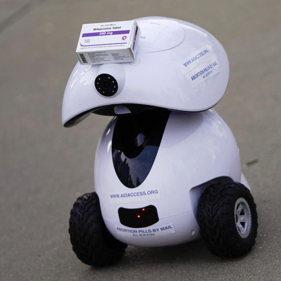 A robot carries a box of mifepristone during a rally in front of the US Supreme Court on March 26, 2024, in Washington, DC.