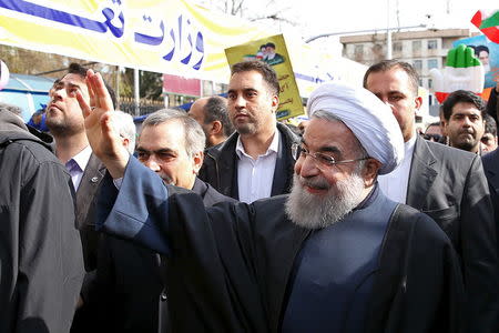 Iranian President Hassan Rouhani waves as he arrives to attend a ceremony marking the 37th anniversary of the Islamic Revolution, in Tehran's Azadi (liberty) Square February 11, 2016. REUTERS/President.ir/Handout via Reuters