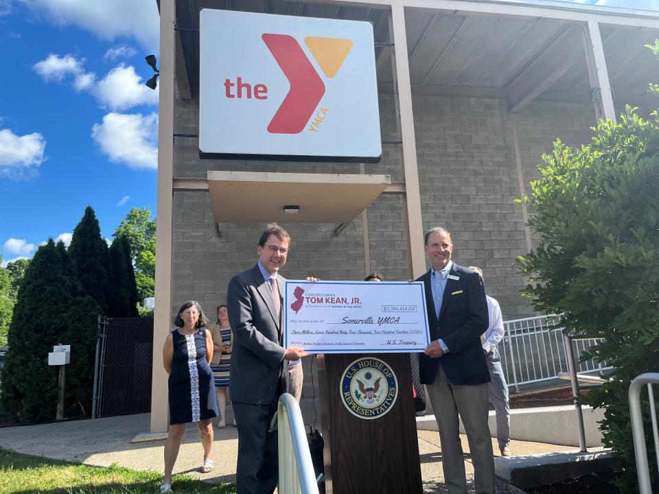 U.S. Rep. Tom Kean Jr. presents a check to the Somerville YMCA.