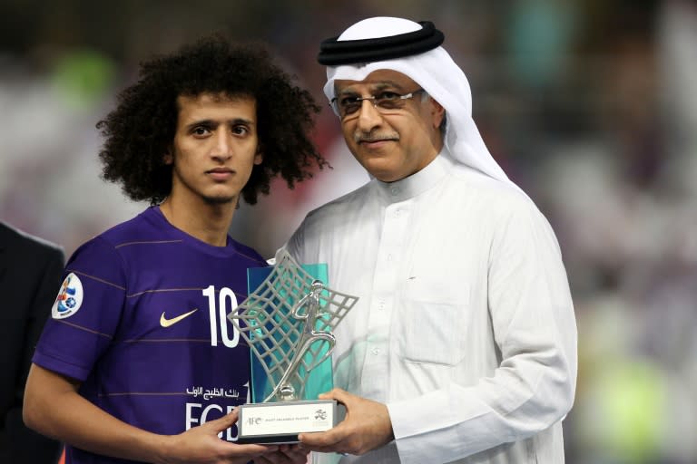 President of the Asian Football Confederation Shaikh Salman bin Ebrahim Al Khalifa (R) presents Al-Ain's midfielder Omar Abdulrahman with the man of the match trophy on November 26, 2016