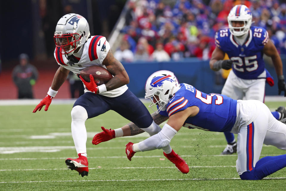 New England Patriots wide receiver DeMario Douglas, left, gets past Buffalo Bills defensive end AJ Epenesa during the second half of an NFL football game in Orchard Park, N.Y., Sunday, Dec. 31, 2023. (AP Photo/Jeffrey T. Barnes )